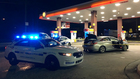 Group Wearing Halloween Masks Shoots Woman